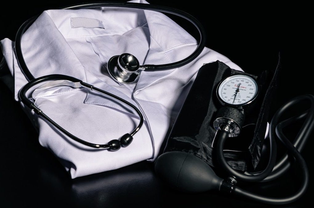 black and silver stethoscope on white textile